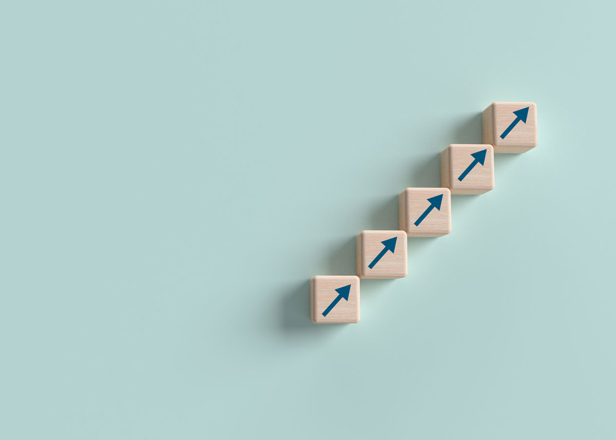 Arrows on wooden blocks all line up and point in the same direction