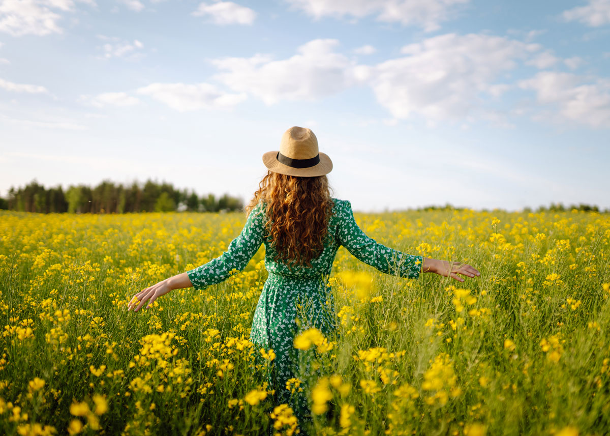 young woman in a field of dandelions